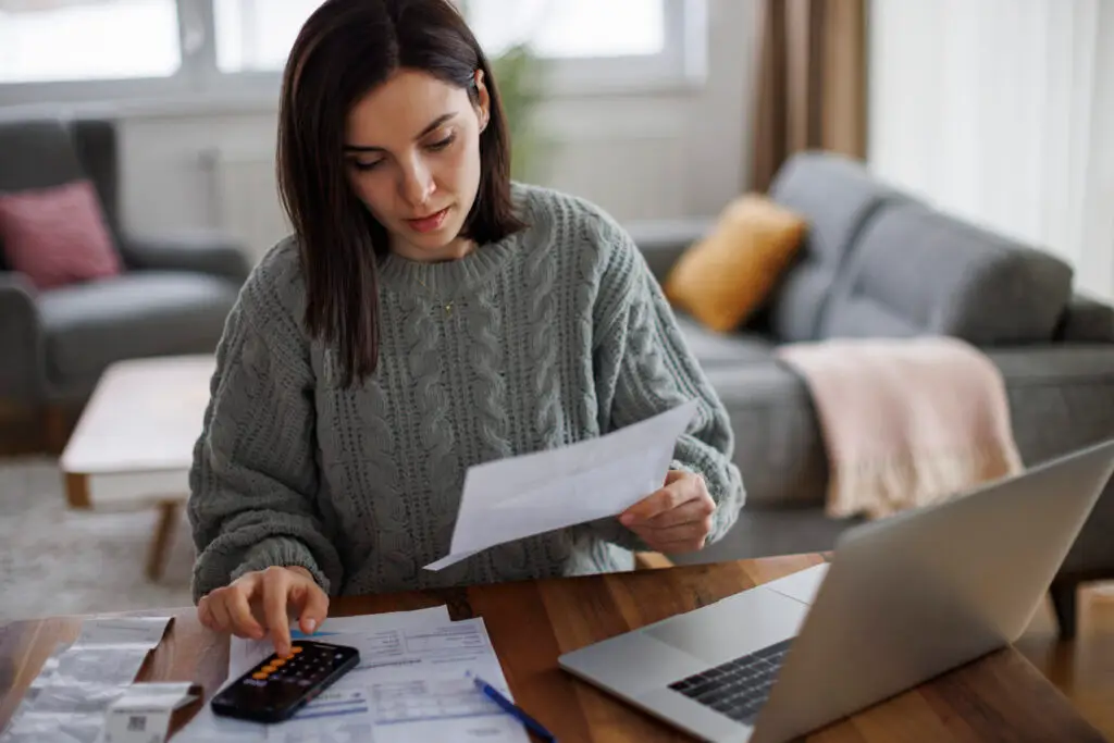 Woman checking her tax strategy, monthly expenses and statements at home