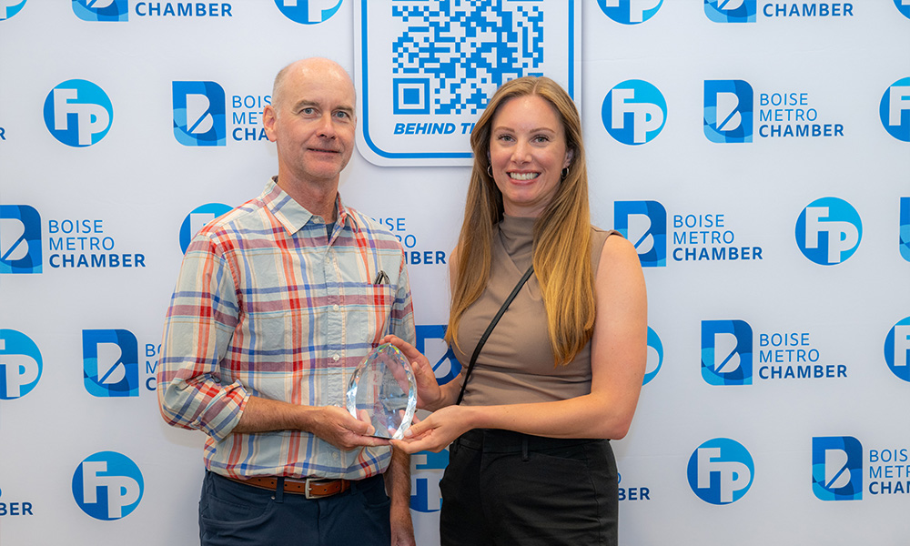 Two Sorren team members holding the Boise Metro Chamber Excellence Award.